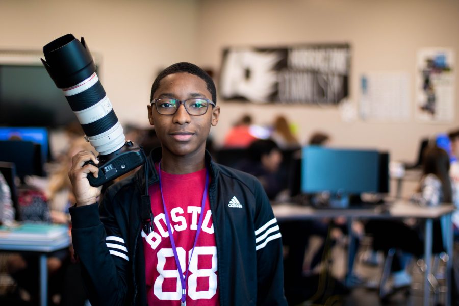 Tyler Grosvenor, the Yearbook Photo Editor, stands in his natural element, the yearbook room. Photo by Enrique Paz