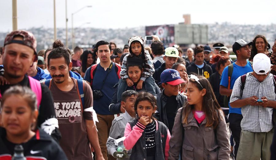 Members of a caravan of migrants from Central America walk towards the United States border and customs facility in Tijuana, Mexico, April 29, 2018. (Edgard Garrido/Reuters)