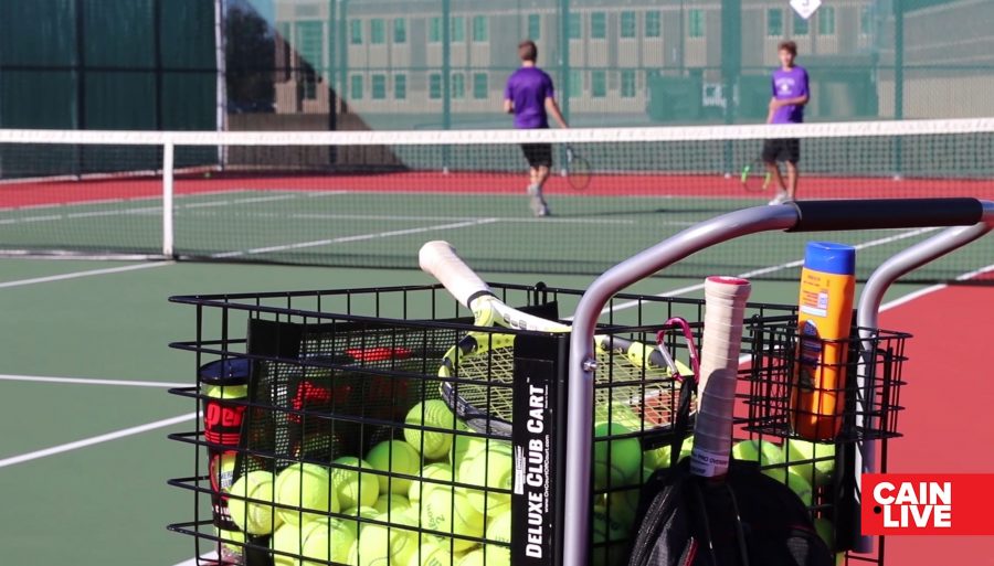 The Tennis Team practicing boys doubles on the Klein Cain courts.
