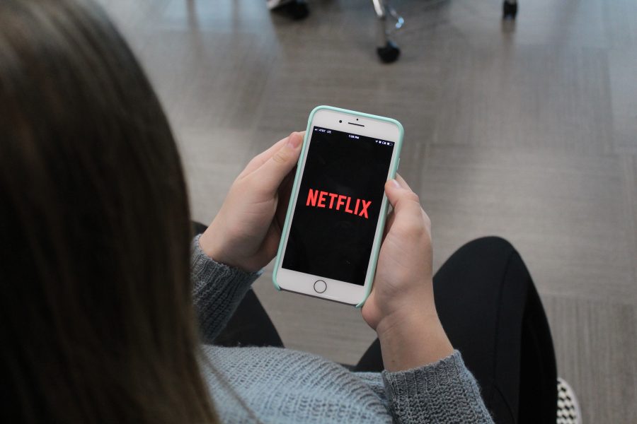 Klein Cain student checks the Netflix app on her phone. Photo by Nathan DeSimone