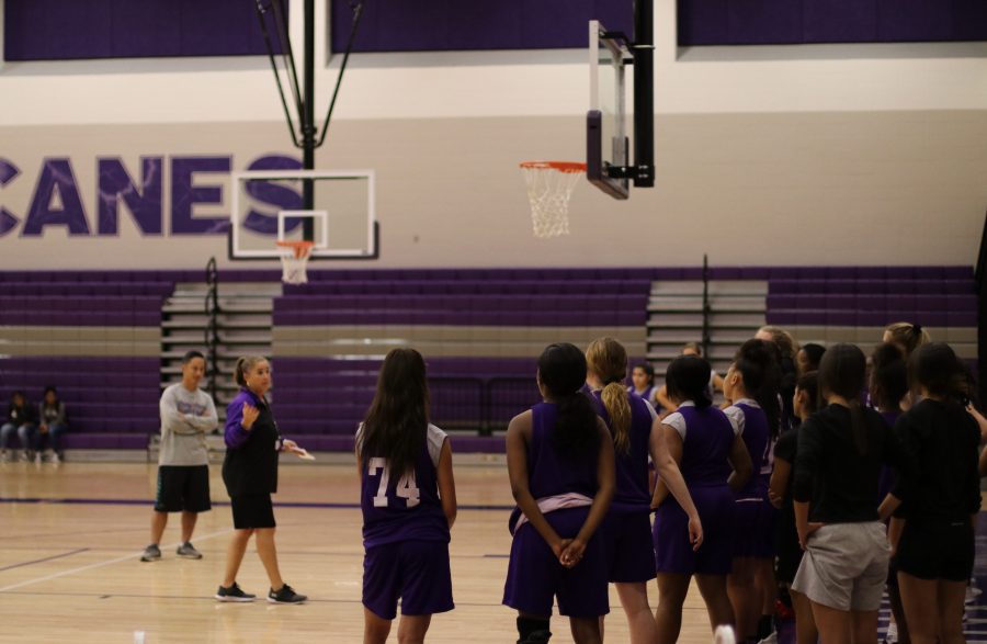 Coach Melissa Fields instructs students what to do during basketball tryouts. Photo by: Douglas Pham