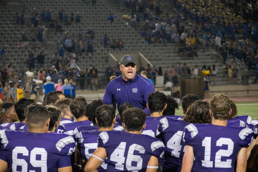 Coach James Clancy encourages the football team. Photo by: Piotr Fraczek