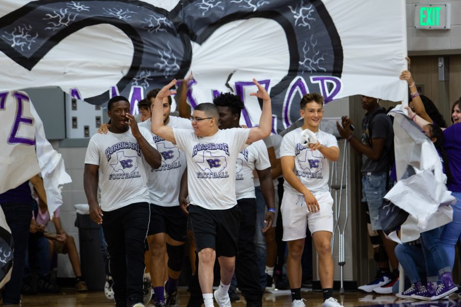 Jacob Munoz making an entrance at the pep rally alongside some football players. Photo by: Tyler Grosvenor