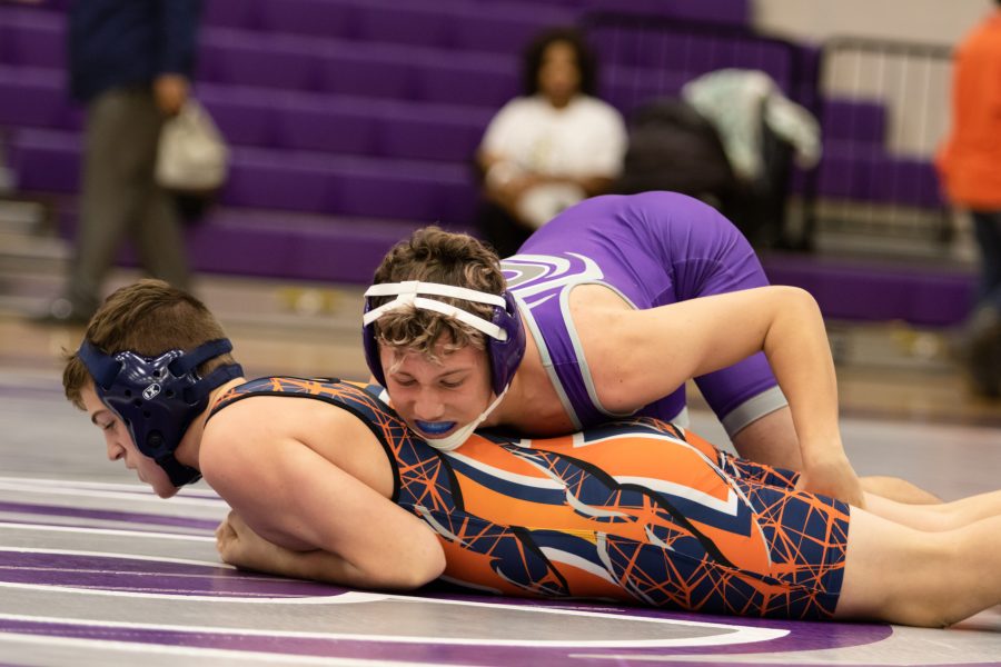 Klein Cain wrestler wrestles another wrestler from Cypress Park. Photo by: Tyler Grosvenor