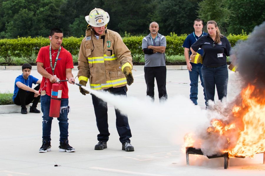 A student extinguishes a fire at a CTE fire event. Photo by: Tyler Grosvenor