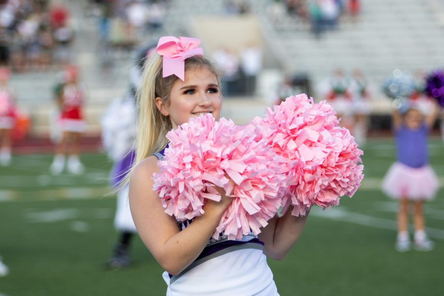 Kaitlyn Patton cheering with her pom poms. Photo by: Charlotte Gottfried