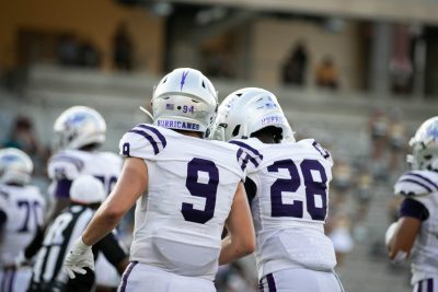 Zach Siefkas and Dernie Christophe walking side by side near the sidelines. Photo by: Zoe Rivers