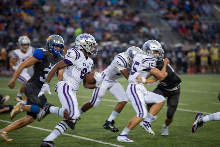 Matt Golden gains yardage against Klein High defenders as Cade Farragut (15) and Charles Jones (24) clear the way. Photo by Charlotte Gottfried.