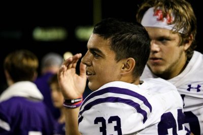 Munoz standing alongside his football companion Aidan Martin on the sidelines. Photo by: Enrique Paz