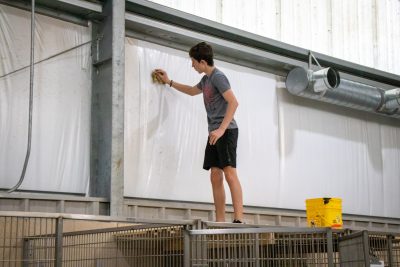 Paws for purpose student cleaning up the Abandoned animal rescue shelter. Photo by: Briana Jones. 