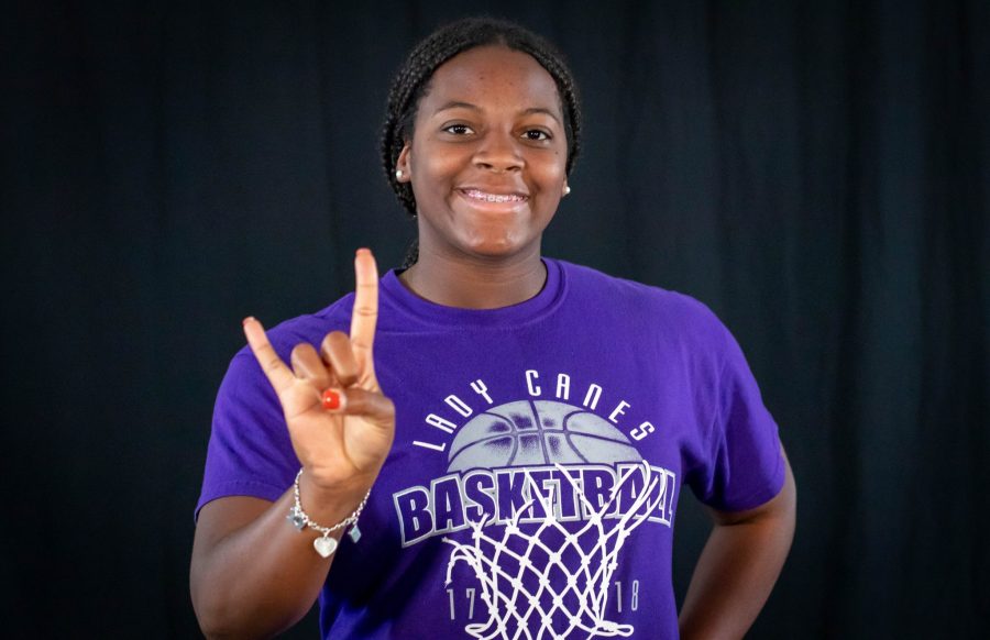 Kiana Lowery doing the University of Texas' sign "hook em." She's committed to joining the University of Texas' track team. Photo by: Charlotte Gottfried