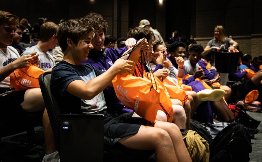 Varsity football team at Klein Cain opening their gifts from Whataburger after Jacob accepted his scholarship. Photo by: Zoe Rivers