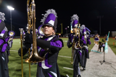 Trombone player Wyatt Ferguson Marching in time during one of his sets near the sidelines. Photo by: Tyler Grosvenor