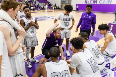 Coach Cook leading the Varsity boys basketball team to a victory. Photo by: Tyler Grosvenor