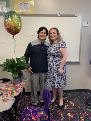 English teacher and football Andres Gomez accepting his teacher of the year award from Nicole Patin.