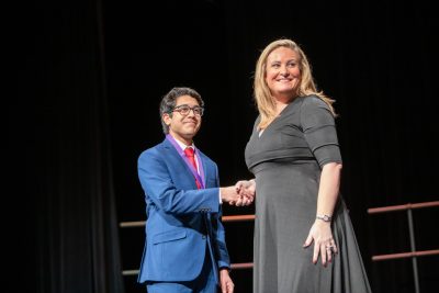 Principal Nicole Patin shaking hands with Sohaib Raja at the auditorium after awarding him a medal for his accomplishment. Photo by Zoe Rivers
