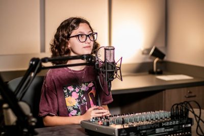 Gracie Solomon interviewing for her podcast about different careers in the sound booth. Photo by: Zoe Rivers