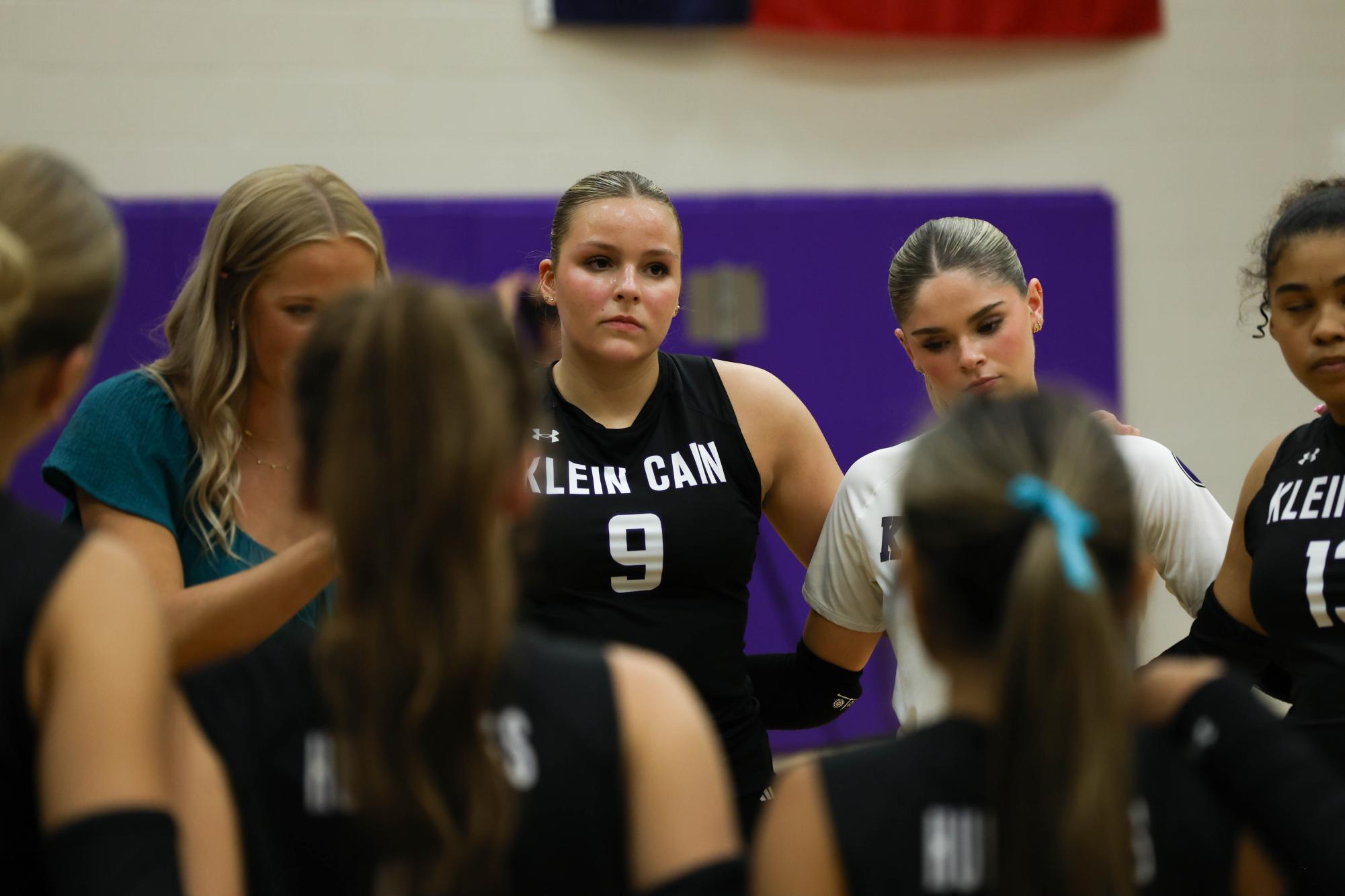 Josie Hoff, Number 9, in huddle with her team. 